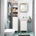 bathroom units a small bathroom with light blue floor tiles, a white high cabinet, LLTEMIU