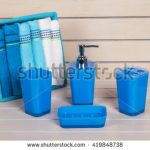 blue bathroom accessories with blue and white on wooden shelf VWKYXGG