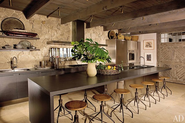 rustic kitchen a stone wall, ceiling beams, and a barnlike door add rustic touches to EHRXVZM