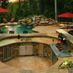 rustic patio with rough cut stone veneer, raised beds, outdoor kitchen,  exterior XJGFPBO
