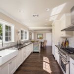 traditional galley kitchen with white cabinets backsplash WAYUHXF