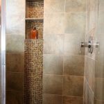 I like when they use accent tile in the vertical. shower ideas