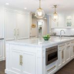 White Kitchen Island with Long Brass Pulls - Transitional - Kitch
