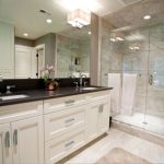 Black granite top over white bathroom vanity | Black vanity .