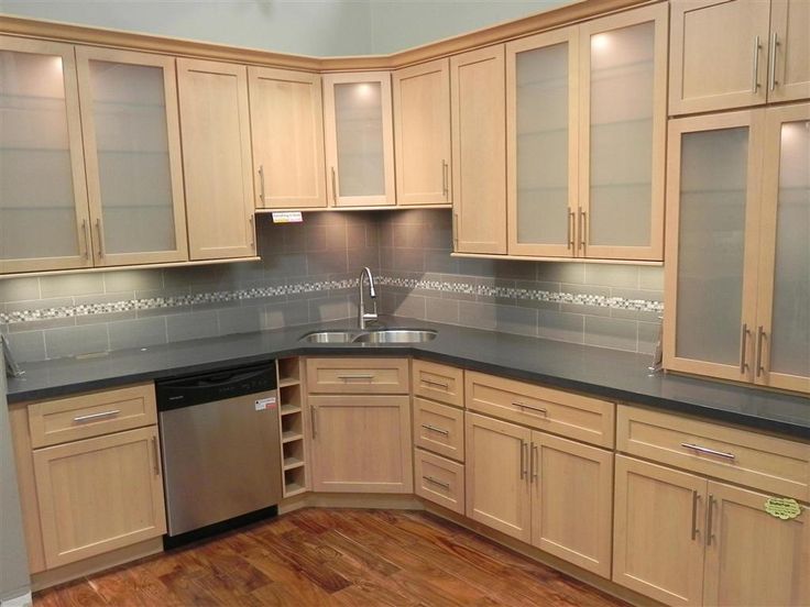 light maple kitchen cabinets with solid grey countertop and grey backsplash GNMKTBY
