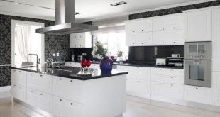 kitchen with white cabinets and black countertops this striking, contemporary kitchen utilizes black counters and bold accent XLLCOBC