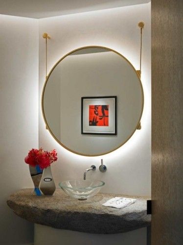 Install lighting behind the hanging mirror in your powder bathroom .