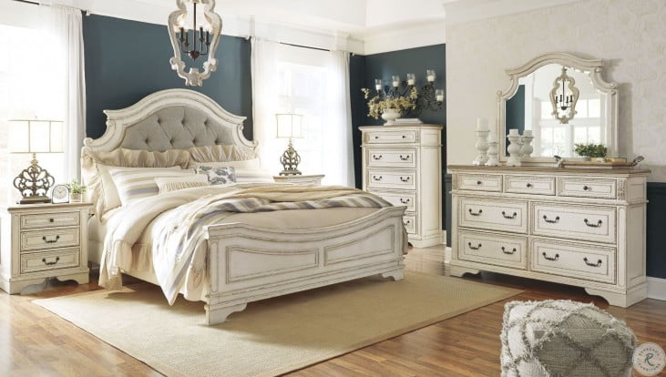 Realyn Chipped Two Tone Upholstered Panel Bedroom Set from Ashley .