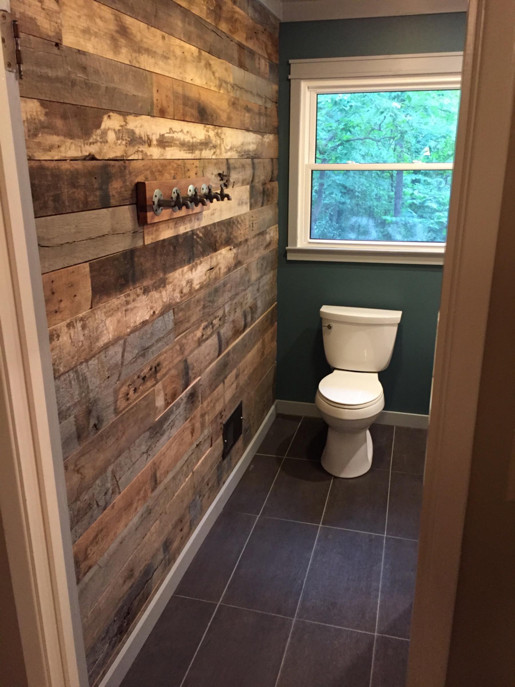 Reclaimed wood accents bring warmth to a minimalist wooden bathroom